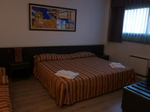 Una cama o camas en una habitación de Green Hotel