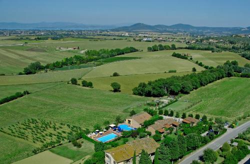 an aerial view of a house with a pool in a field at Agriturismo Tenuta Badia in Paciano