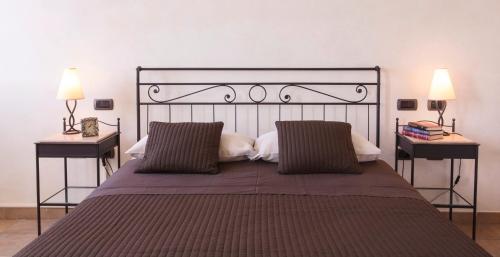 a bedroom with a large bed with two side tables at B&B Residence il Ciliegio , Via Villa Superiore 93 Luzzara in Luzzara