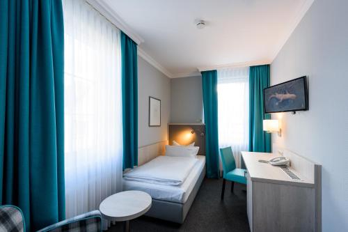En eller flere senge i et værelse på Hotel Braunschweiger Hof