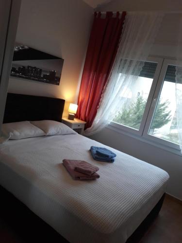 a bedroom with a bed with two towels on it at Τhe Diamond in Nea Peramos