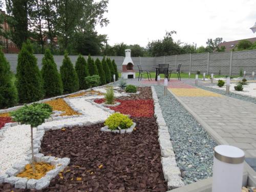 a garden with a flower bed with a fountain at Apartamenty Energo in Bytom