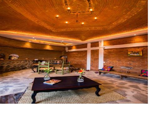 a living room with a table and a couch at Hotel Boutique Rincon Sagrado in Atlixco