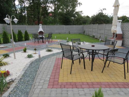 a patio with a bunch of chairs and tables at Apartamenty Energo in Bytom