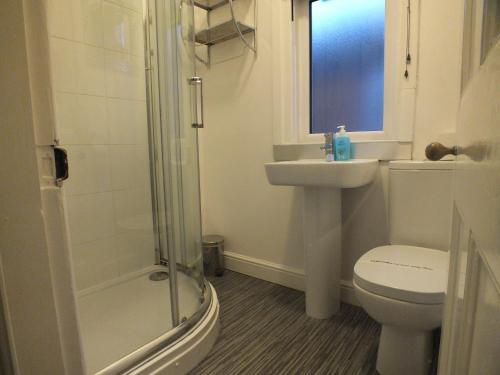 a bathroom with a toilet and a sink and a shower at Walthall Place by SG Property Group in Crewe