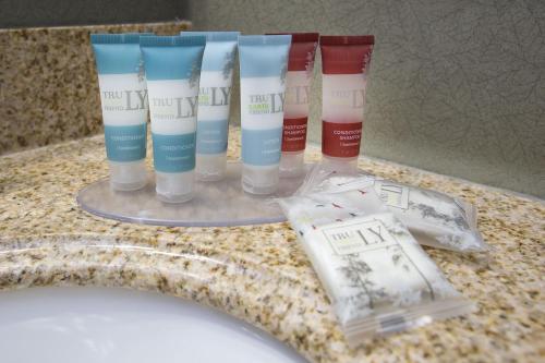 a group of four toothbrushes sitting on a counter next to a sink at The Oakes Hotel Overlooking the Falls in Niagara Falls