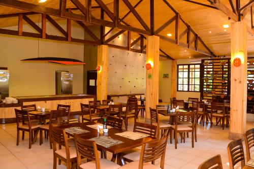a dining room with wooden tables and chairs at Rio Quente Resorts - Eco Chalés in Rio Quente