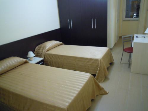 Un ou plusieurs lits dans un hébergement de l'établissement Hotel Happy