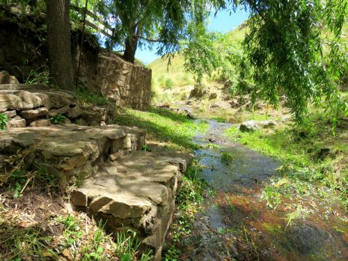 a stone wall and a path in a field at Estancia Altos del Durazno in Estancia Grande