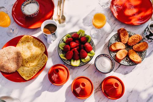 uma mesa coberta com pratos de alimentos e frutas em P´tit Habibi em Marrakech