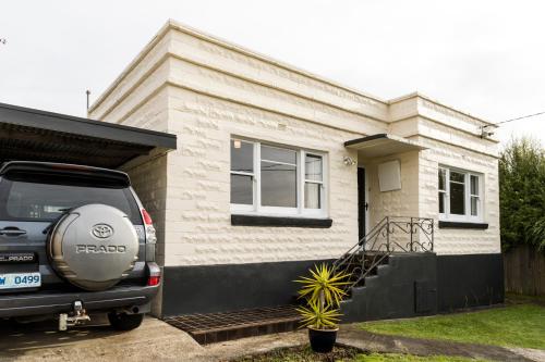 a car parked in front of a house at Burnie City Apartments in Burnie