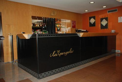 a bar in a restaurant with a sign on it at Hotel La Pergola in Grezzana