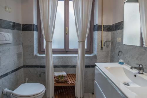 フィレンツェにあるDowntown suite Florenceのバスルーム(トイレ、洗面台付)、窓が備わります。