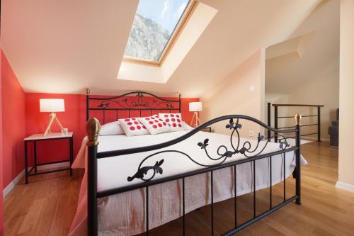 a bedroom with a bed and a skylight at House Pasalich in Tučepi