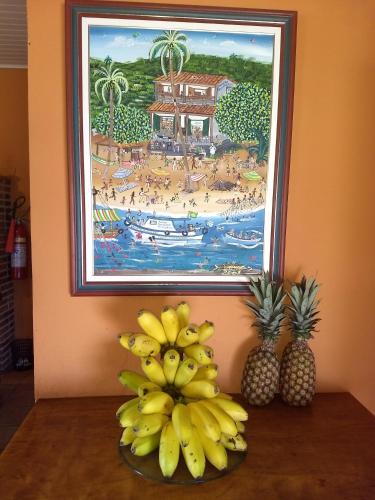 a painting of a beach with a bunch of bananas at Pousada Tony Montana in Praia de Araçatiba