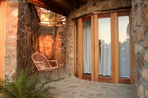a patio with a chair and a window at Hotel Sal de Mar in San Agustinillo