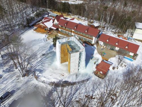 an aerial view of a building in the snow at Iwane Sanso in Kawakami