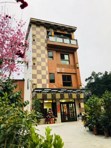 a tall building with a store in front of it at Sin Ging Hong Resort in Lugu