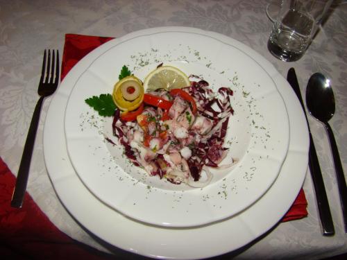 a white plate of food on a table at Domačija Vodnik & Apartments in Cerklje na Gorenjskem