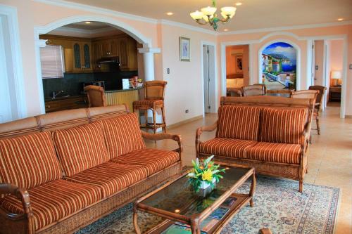 a living room with two couches and a table at Breakfast at Monaco - Palais Boracay in Boracay