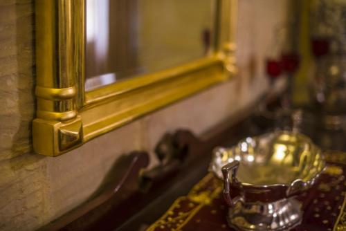 a bathroom sink with a gold mirror and a sink at Ta' Bertu Host Family Bed & Breakfast in Ħal Far