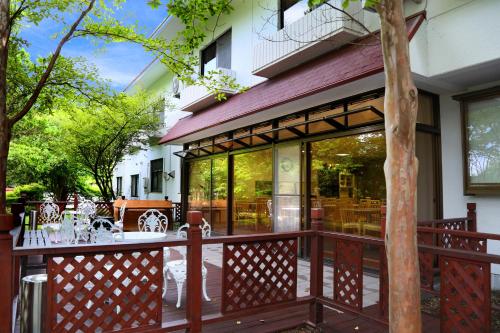 a wooden deck with a table on a patio at Asia Hotel FUJISAN in Yamanakako