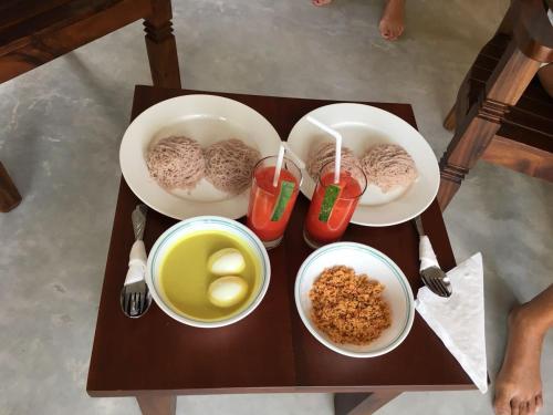 a table with three plates of food on it at Villa Marina in Hikkaduwa