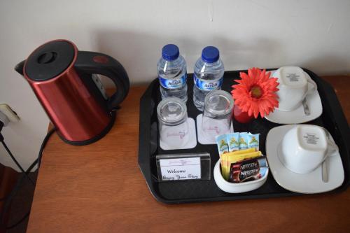 a tray with bottles of water on a table at Jambura Inn in Gorontalo