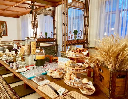 a table with bread and baskets of food on it at HOTEL Jerolitsch in Krumpendorf am Wörthersee