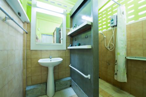 a bathroom with a sink and a toilet and a mirror at 60 Blue House in Chiang Mai