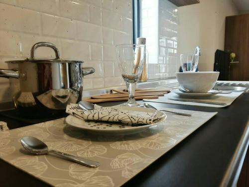 a kitchen counter with a plate and a wine glass at Rangsit Residence in Ban Talat Rangsit