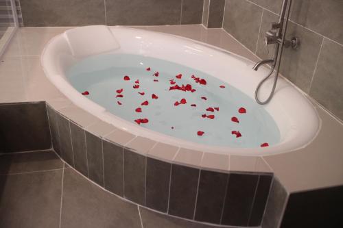 a bath tub with red hearts in it at Thanh Thuy in Cu Chi