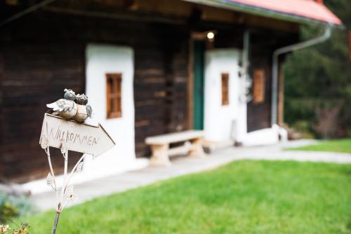 a house with a sign in front of a yard at Landhaus Moser in Leutschach