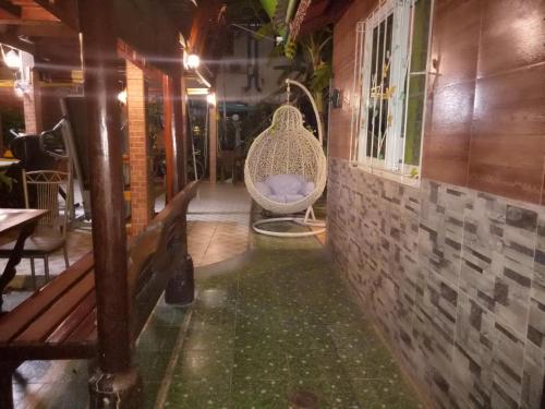 a room with a swinging chair in a building at Ruenthip Homestay in Bangkok