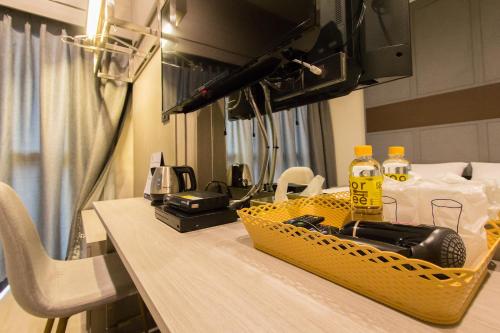 a table with a yellow basket on top of it at Lazy Sunday hostel in Bangkok