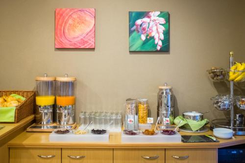 a counter with a coffee maker and some food at Hotel-Pension Wild in Vienna