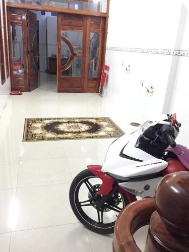 a motorcycle parked in a room with a door at Nhà nghỉ Sunrise in Quy Nhon