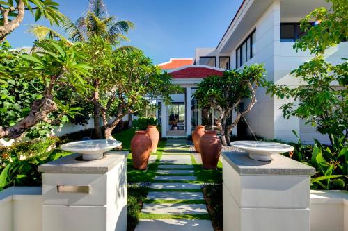 a garden with two sinks in front of a house at The Ocean Villas Managed by The Ocean Resort in Da Nang