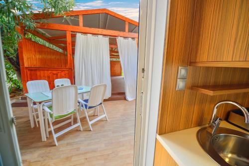a kitchen with a table and chairs on a patio at Hotel Peli in Kissamos