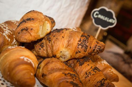 a pile of croissants and other pastries on a plate at Art Hotel Milano in Prato