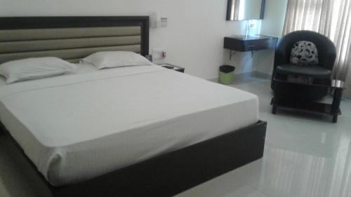 Ένα ή περισσότερα κρεβάτια σε δωμάτιο στο Rio Grande Residency
