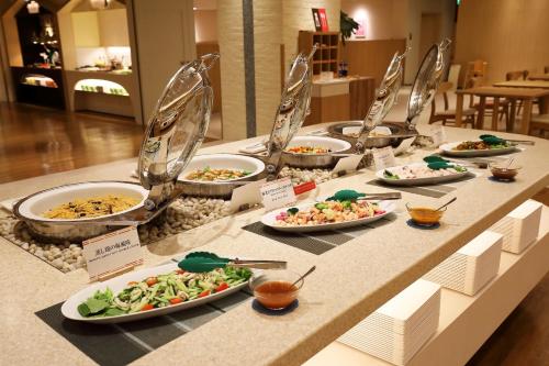 a buffet with plates of food on a table at Heiseikan Shiosaitei Hanatsuki in Hakodate