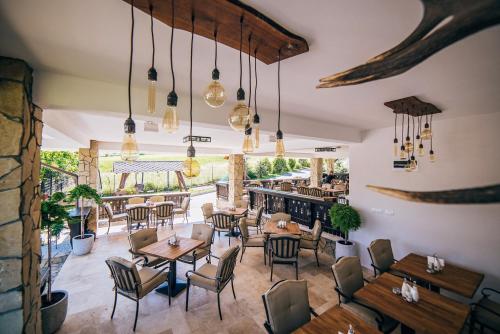 a restaurant with tables and chairs and a bar at Pension Casa Humor in Gura Humorului