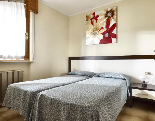 En eller flere senge i et værelse på Tonini Apartments