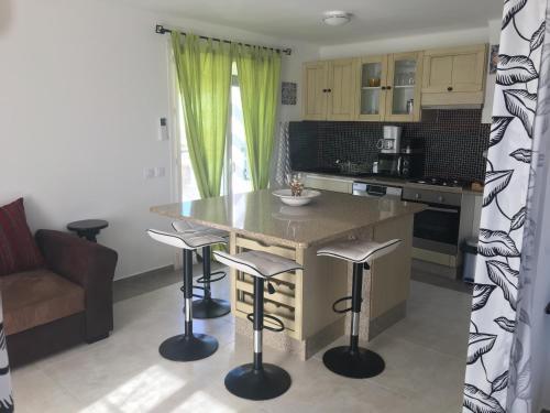 a kitchen with a large island with bar stools at Villa Santo Antonio in Serra do Mouro