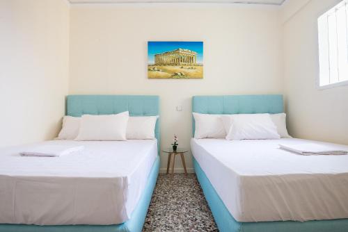 A bed or beds in a room at Acropolis View Paradise Apartments