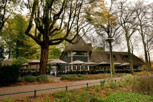 a large building with a tree in front of it at B&B Limes Oudwijk in Utrecht