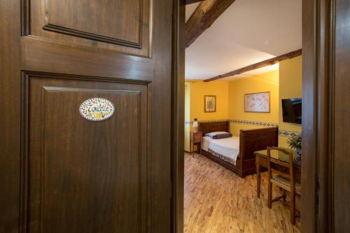 a door to a room with a bed and a bedroom at B&B Contrada dei Giardini in Cuneo