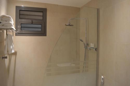 a bathroom with a shower with a glass door at Rafa Homes Al Izdihar 1 in Riyadh