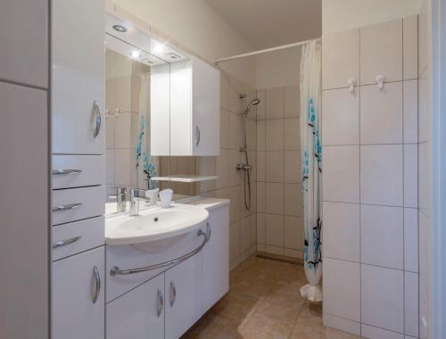 a white bathroom with a sink and a shower at WN Rooms in Wiener Neustadt